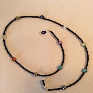 Black and glass pearl eye glass holder